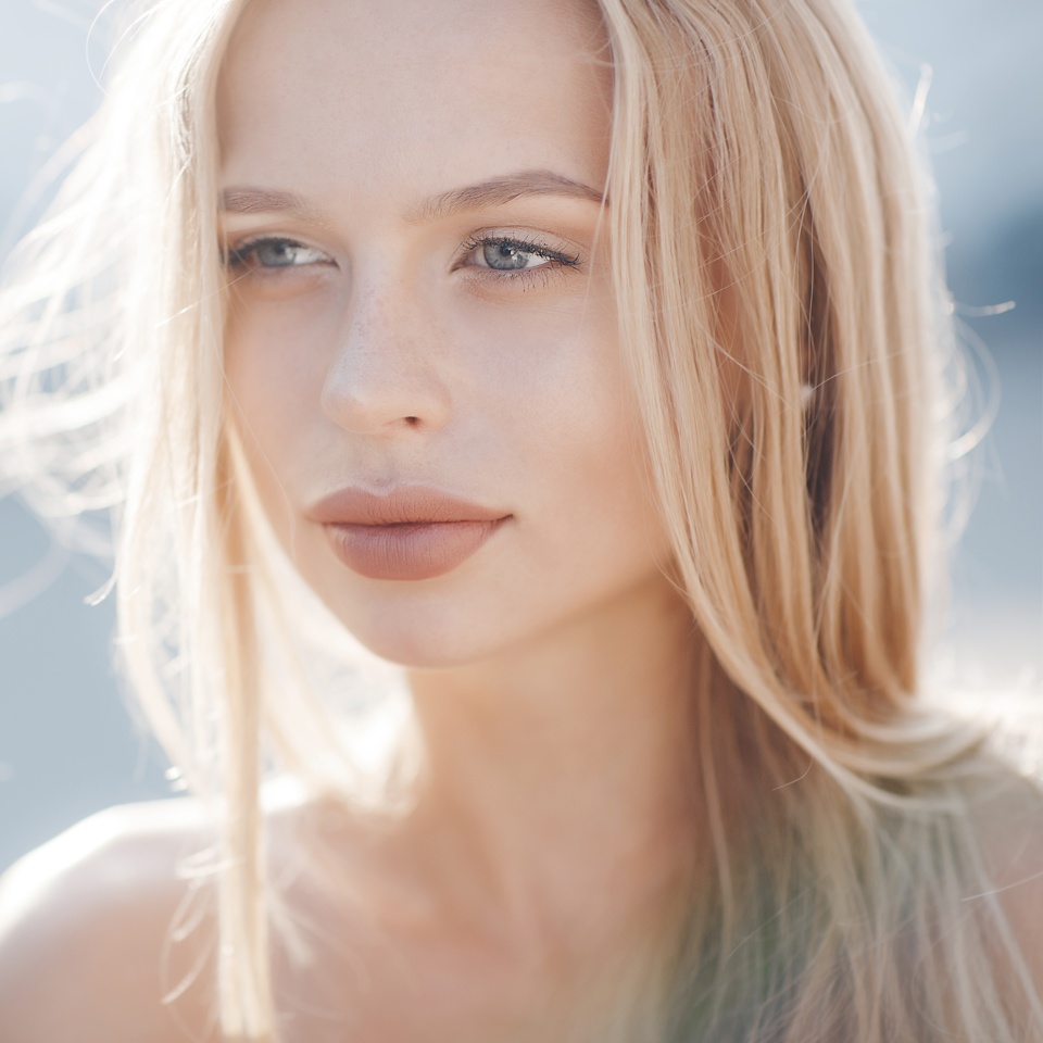 Portrait Of Young Smiling Beautiful blonde Woman. Close-up portrait of a fresh and beautiful young fashion model posing outdoor. Summer outdoor photo
