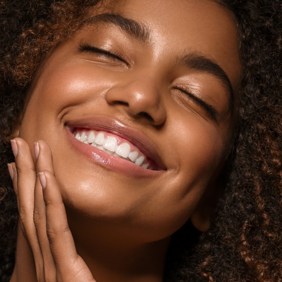 Beautiful african american woman face close up teeth smile happy positive