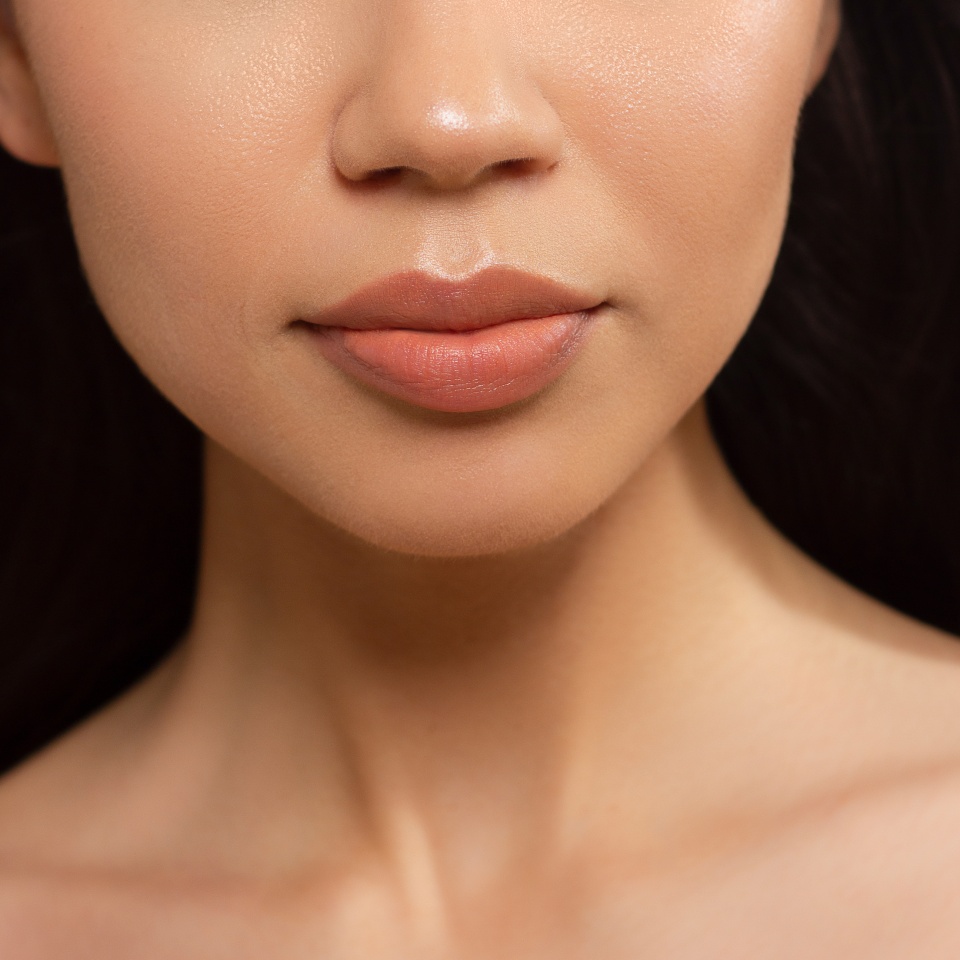 Sexual full lips. Natural gloss of lips and woman's skin. The mouth is closed. Increase in lips, cosmetology. Natural lips. Great summer mood with open eyes. fashion jewelry. Pink lip gloss