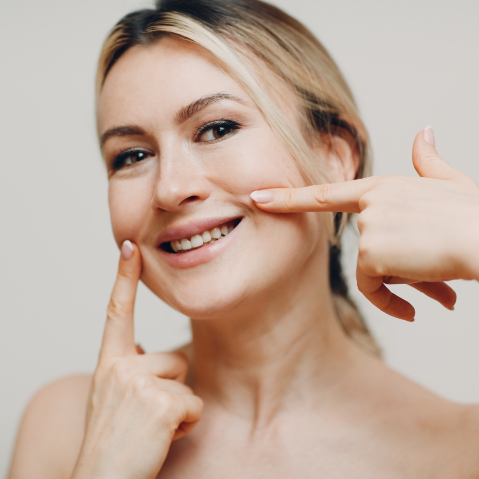 Young adult smile woman doing facial gymnastics self massage and rejuvenating exercises face building and lifting