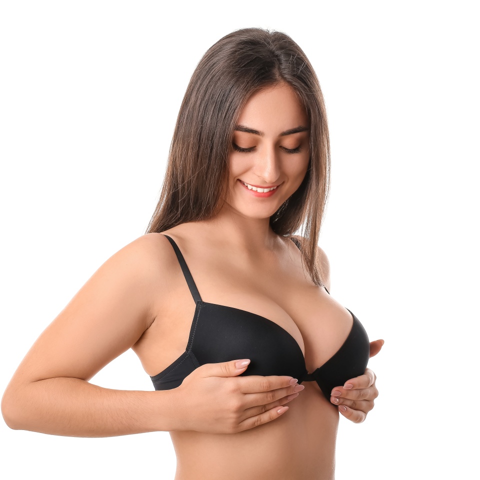 Young woman in bra on white background