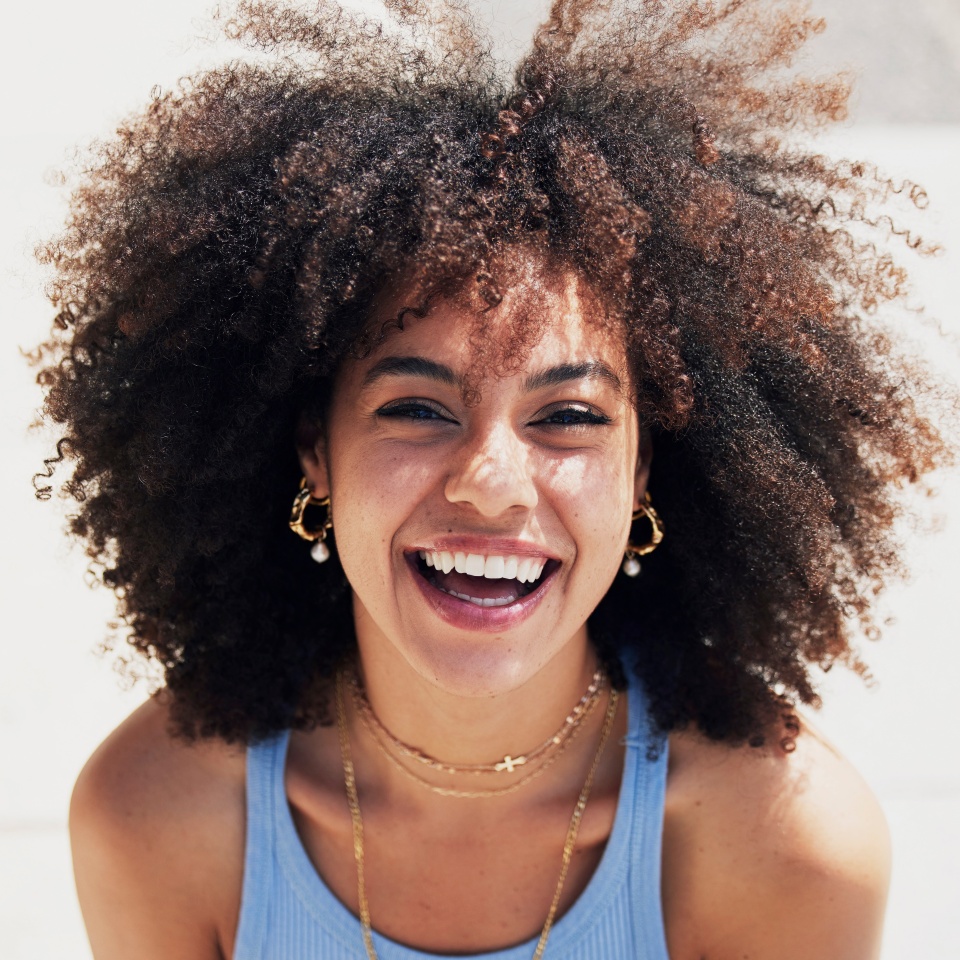 Black woman, happy in portrait with fashion and beauty outdoor, street style with natural hair, makeup and jewelry. Freedom, happiness and mockup with afro, person in Cape Town with mindset and glow
