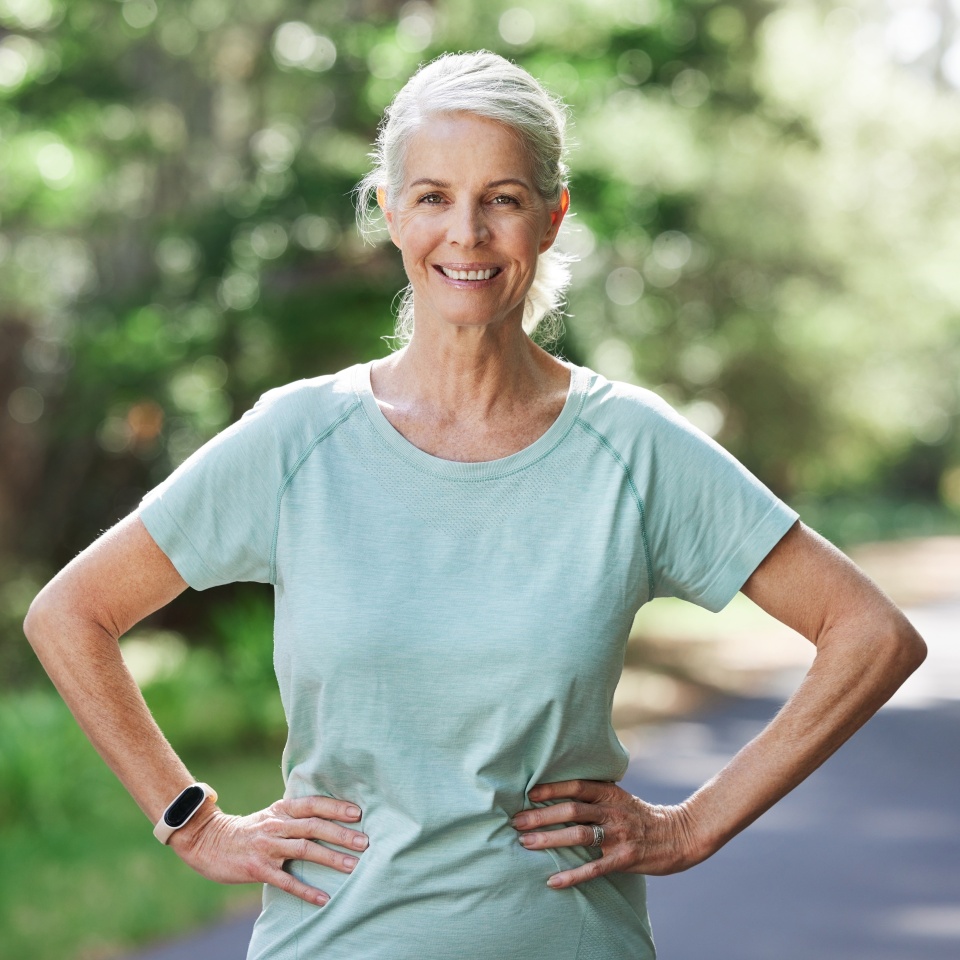 Senior woman, exercise and outdoor for a run, workout and training on road with trees for fitness. Elderly female person happy about cardio for health and wellness while walking or running in summer