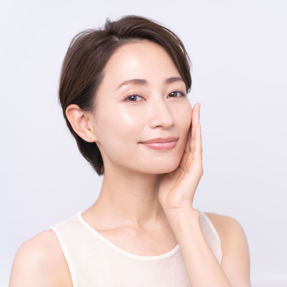 Beauty portrait.Asian woman is touching her cheek.