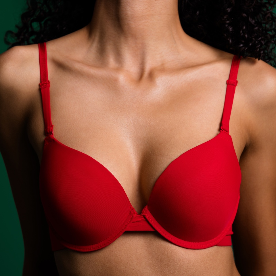 Cropped photo of slender stunning lady neck breast wear red lingerie enjoying herself empty space isolated green color background